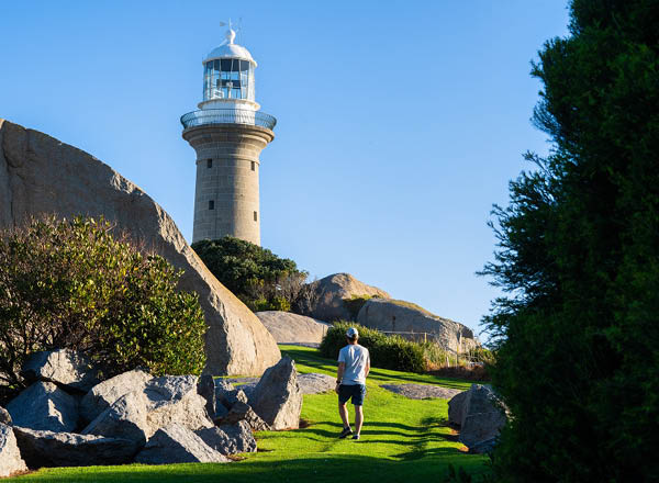 Man walking toward Montague Island Lighthouse
