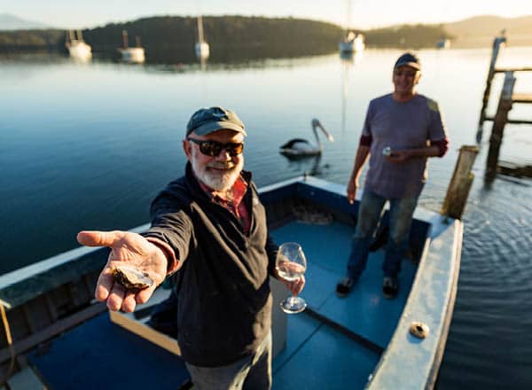 Men on a boat with wine and oysters